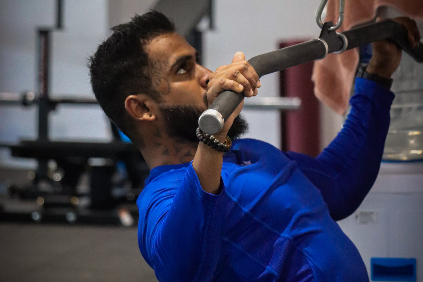 Person lifting a barbell in a gym setting